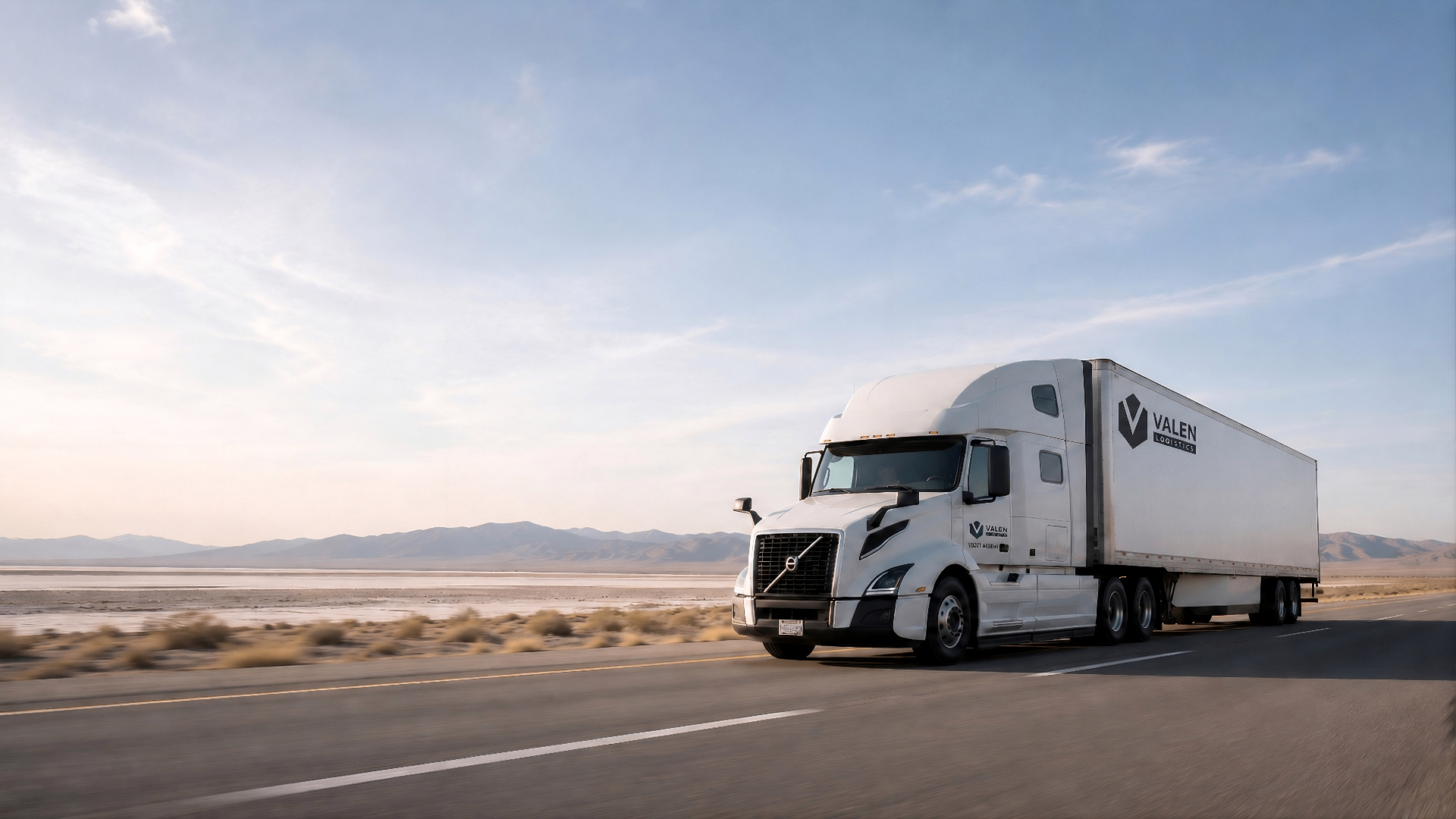 A dry van semi truck on an open American highway at golden hour